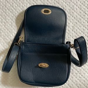 Navy blue pocketbook with gold hardware